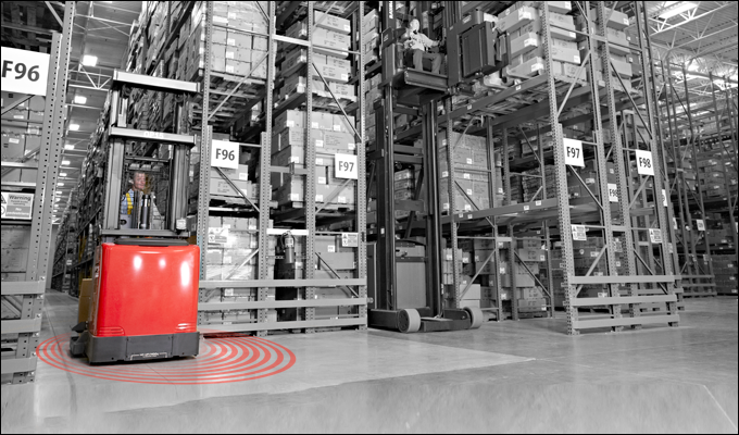 Raymond forklift in a warehouse with red rings on the floor representing the Real-Time Location System. 