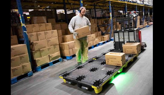 Warehouse operator using Raymond's pick 2 pallet operator assist while picking.