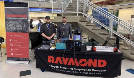 Raymond associates demonstrating a welding simulator at Manufacturing Day