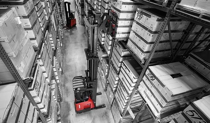 Black and white view of inside of a warehouse material handling