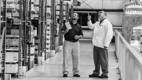 Two people talking in a warehouse
