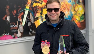 Photo of Ryan Lewis wearing a gold medal