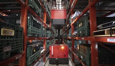 Raymond Automated Transtalker as part of their intralogistics solutions shown in very narrow aisle.