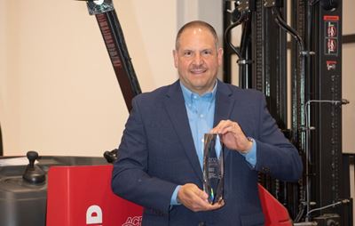 Tony Topenik holds 2021 Manufacturing Leadership Award.