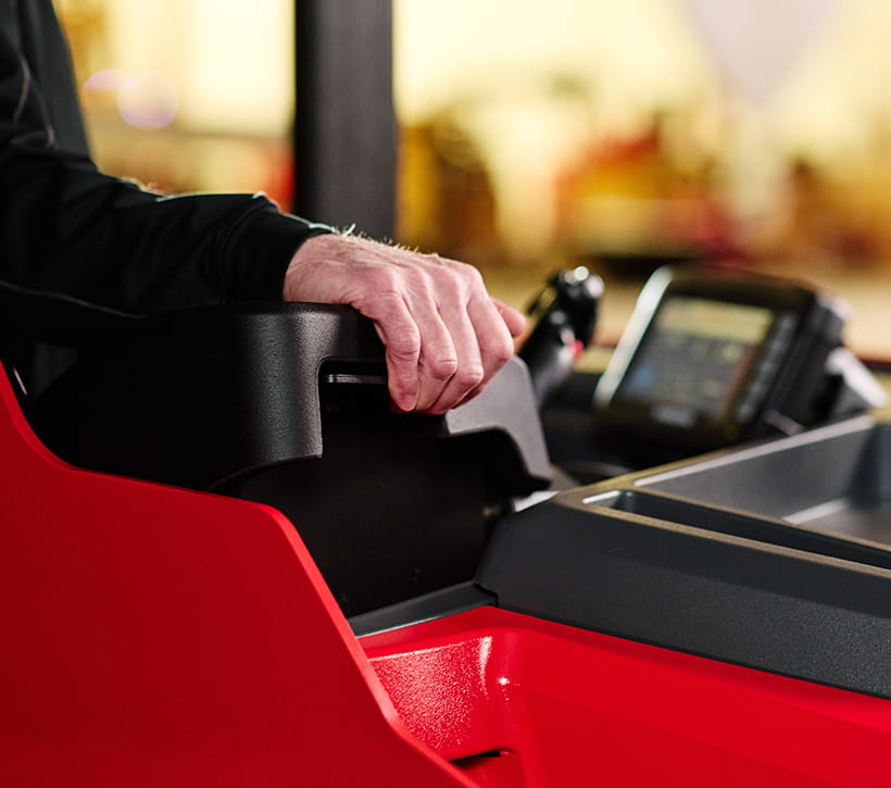 Adjustable armrest on Raymond stand-up counterbalanced forklift designed for ergonomic comfort for operators of different sizes