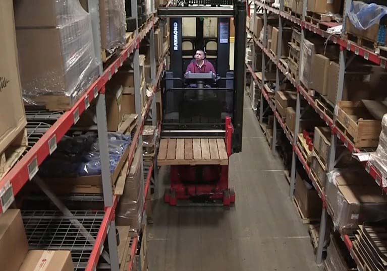 Raymond 9800 Swing Reach Truck in Aisle